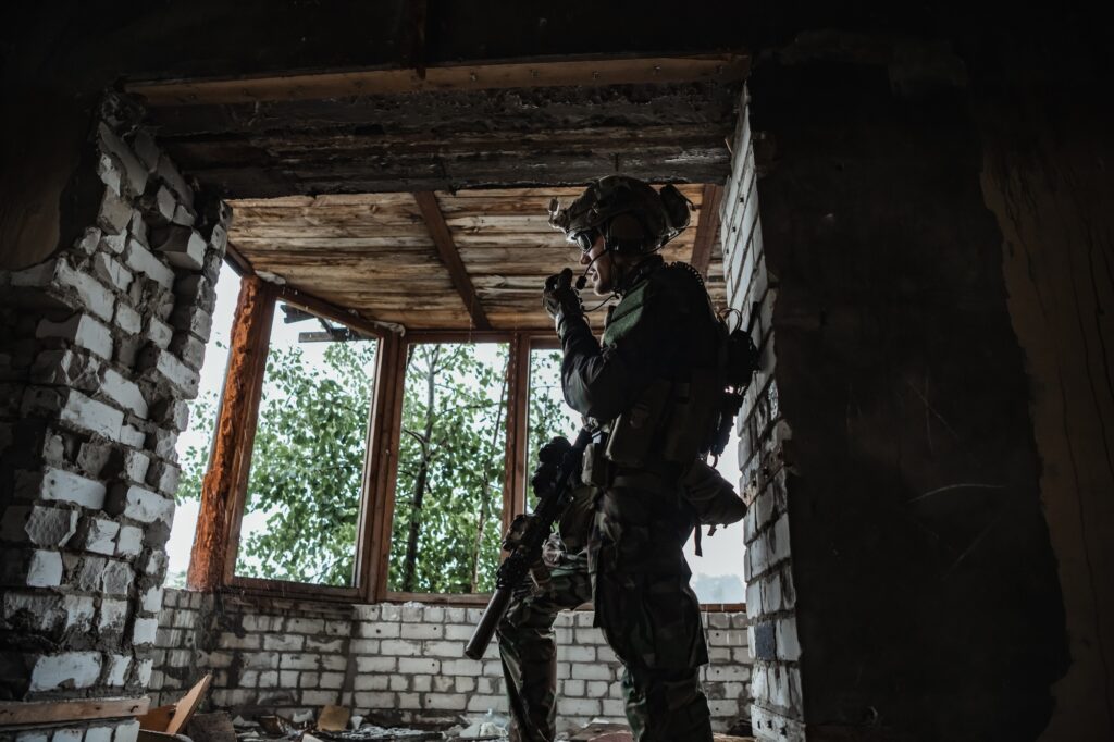 Military man standing inside the building and waiting for command